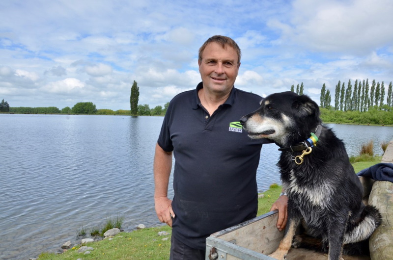 The late Chris Allen, with working dog Ace beside the irrigation lake he created on his farm near...