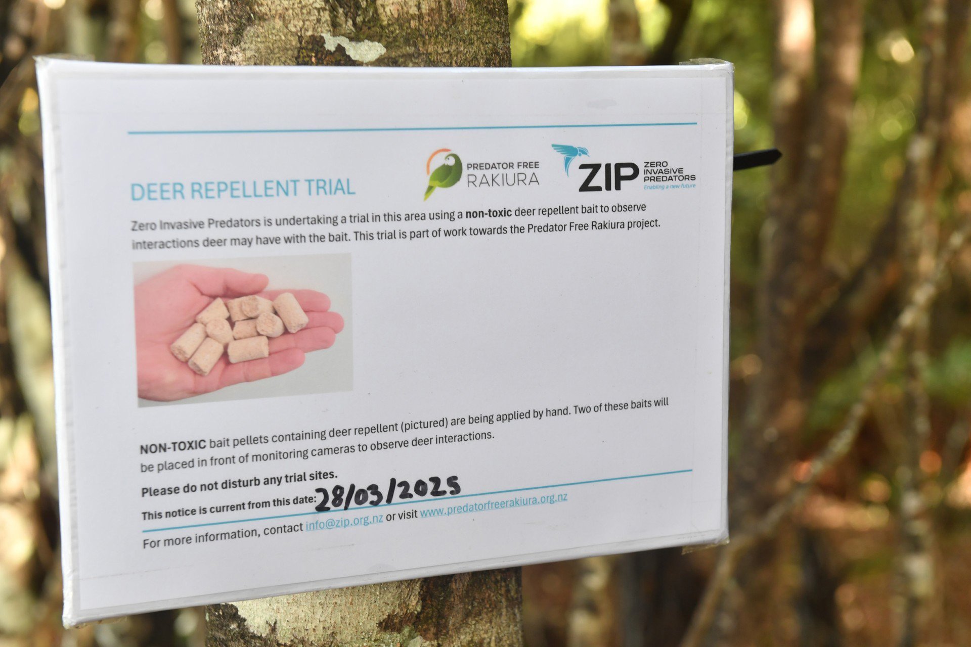 A sign advising Stewart Island visitors of a trial of deer repellent pellets.