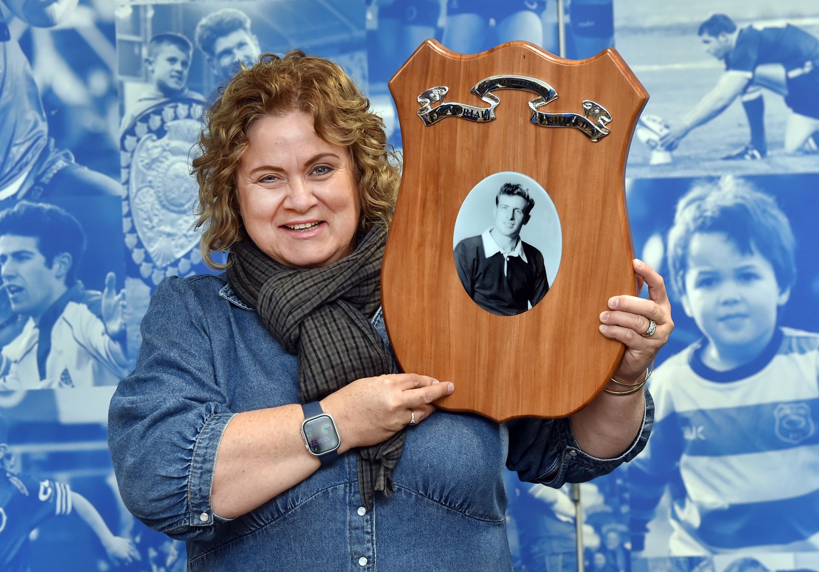 Pip Jones, 56, holds up the new shield which bears the name of her father, Otago rugby great...