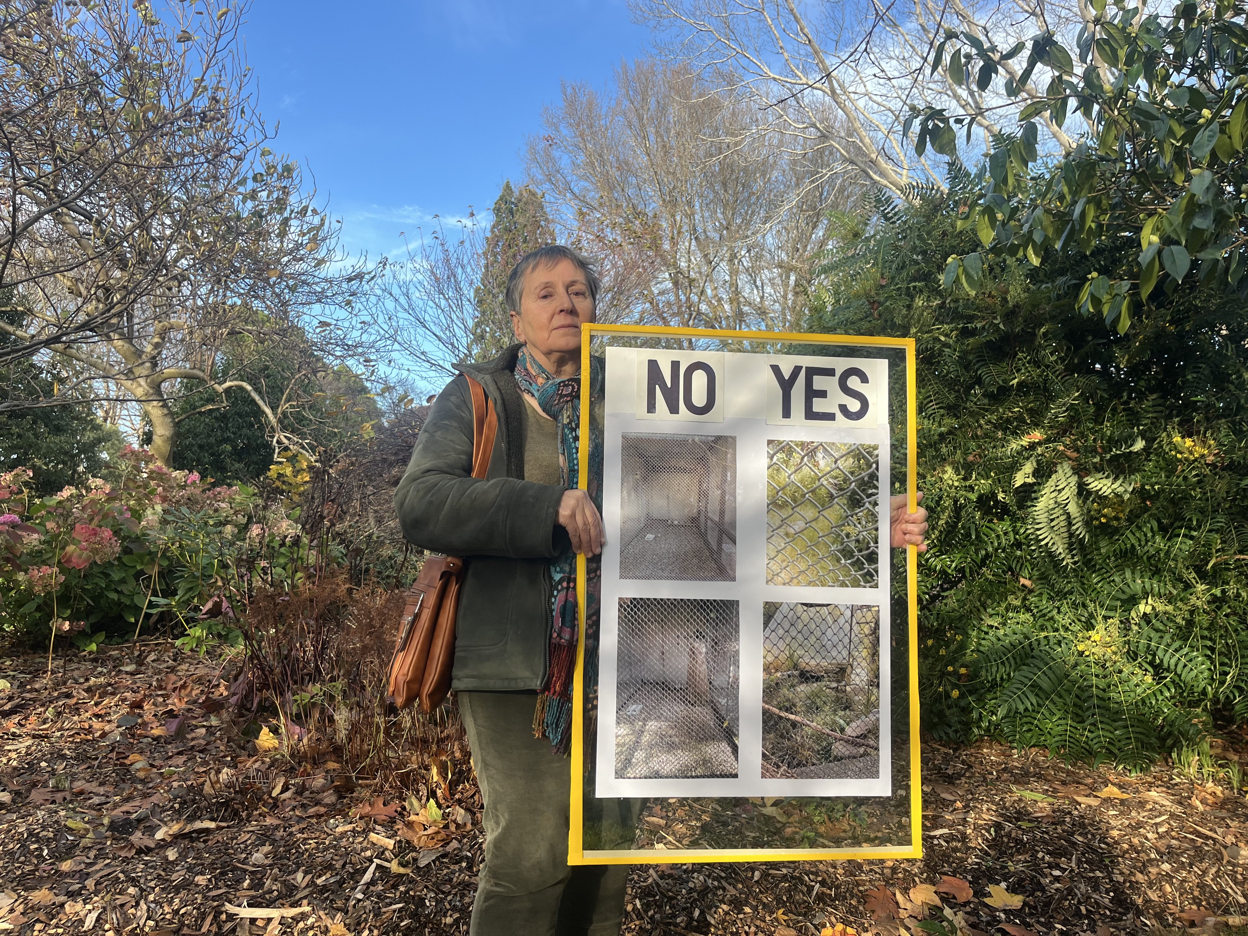 Nikki Broad holds a placard she has made protesting the lack of greenery in Gore aviary. PHOTOS:...
