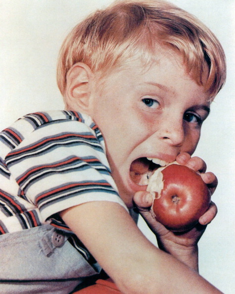 Jay North, US actor, biting into an apple in a portrait issued as publicity for the US television...