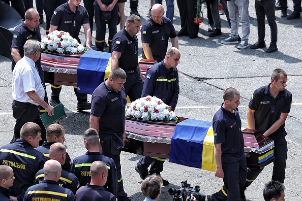 Comrades carry the coffins with the bodies of the fallen rescuers in Kyiv, Ukraine. Photo: Getty...