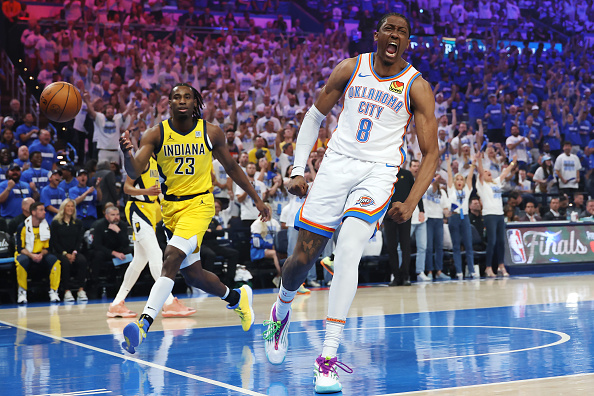 Oklahoma City Thunder's Jalen Williams celebrates a slam dunk as Indiana Pacers guard Aaron...