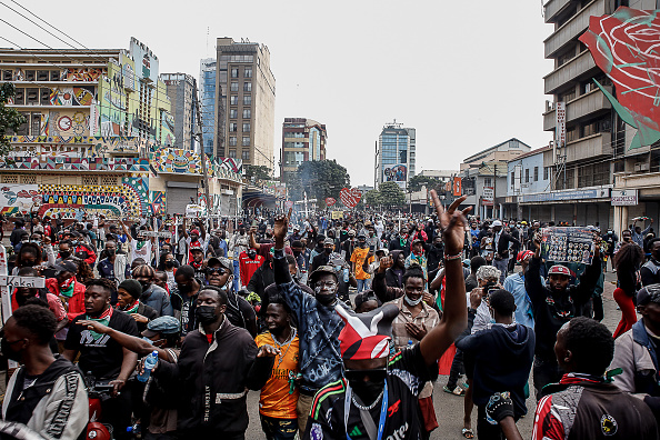 Demonstrators carrying placards with names of the fallen Gen Z heroes walk down town Nairobi...
