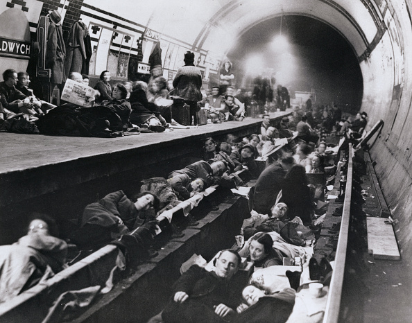 Weary Londoners sleep in the comparative safety of a tube station, taken out of service and...