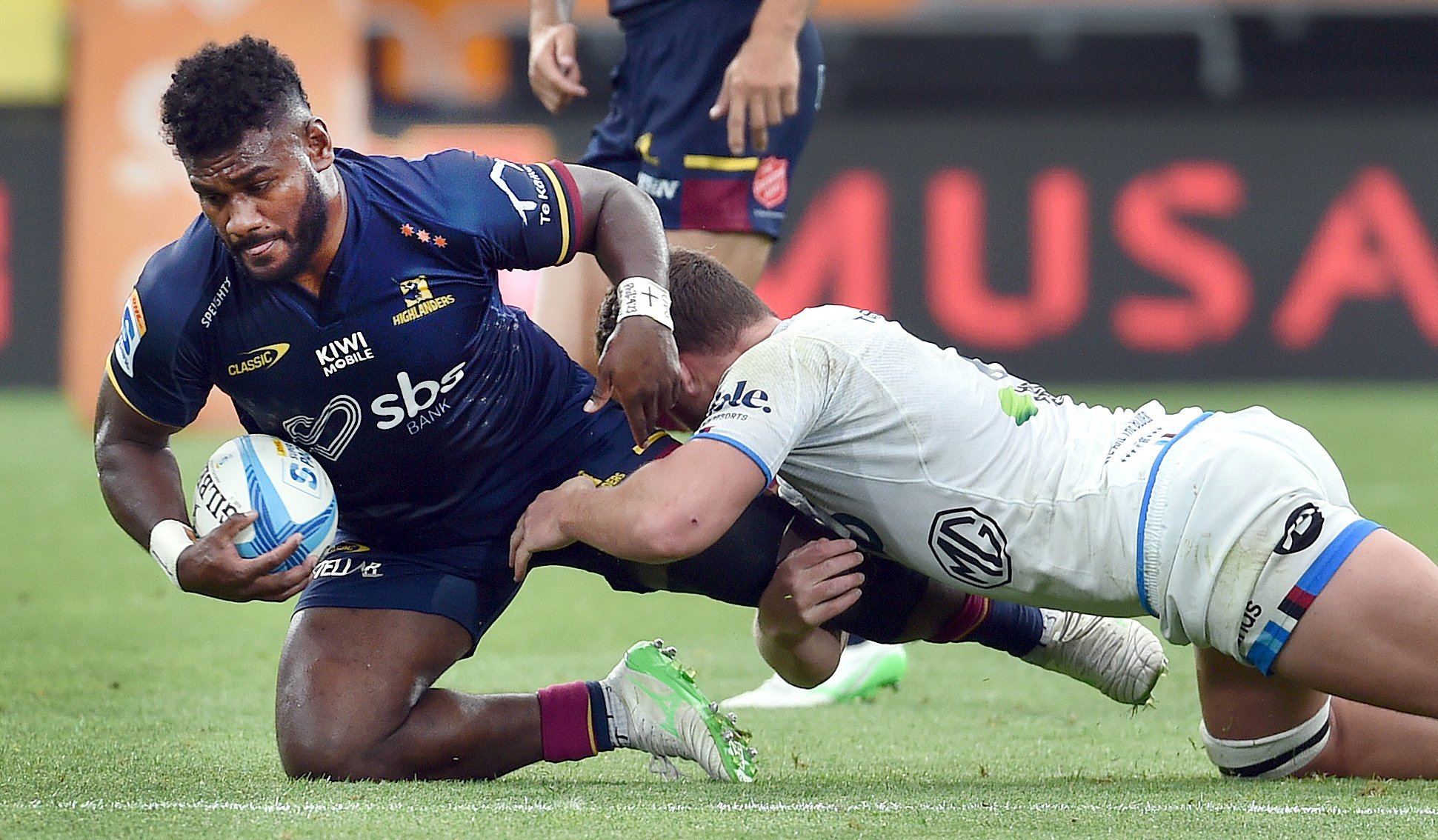 Highlanders midfielder Timoci Tavatavanawai is tackled by Blues flanker Dalton Papali’i during...