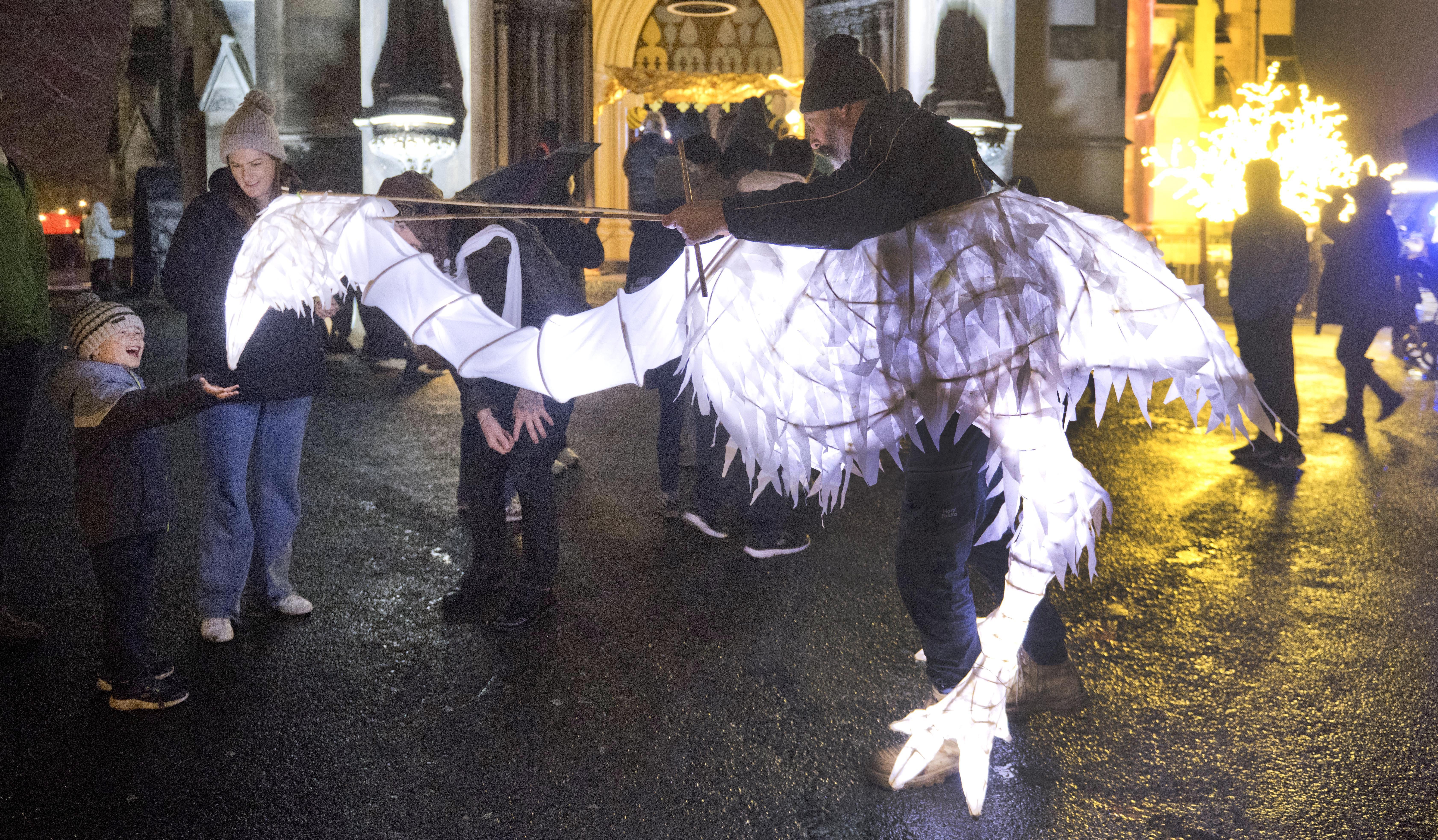 Miguel Weaver in a moa costume plays with Lucas Pearce, 4, while his mother Lauren watches.
