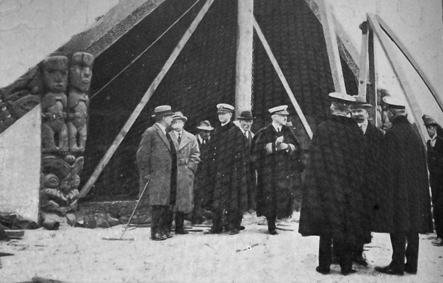 Visiting US Navy officers look at the Mataatua Whare whakairo being assembled at Logan Park for...