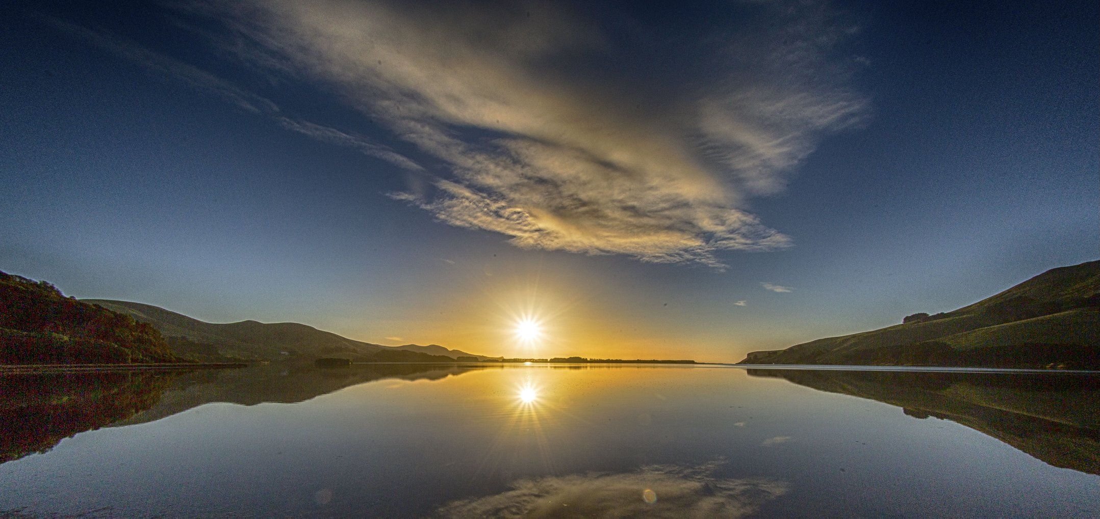 The sun rises over Papanui Inlet. Photo: Ian Griffin