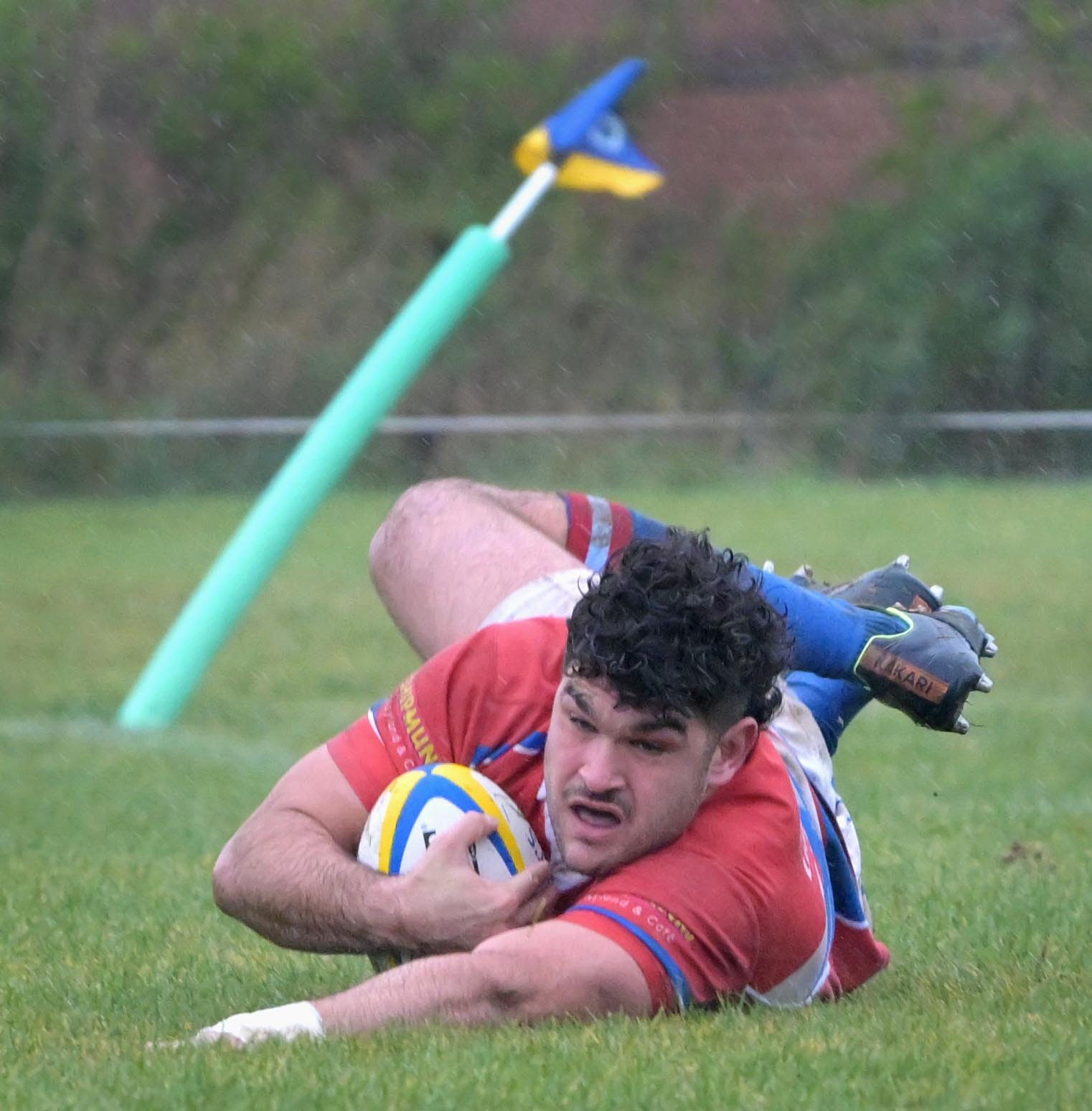Harbour hooker Gabriel Francesconi crashes past a wind-swept corner flag to open the scoring...