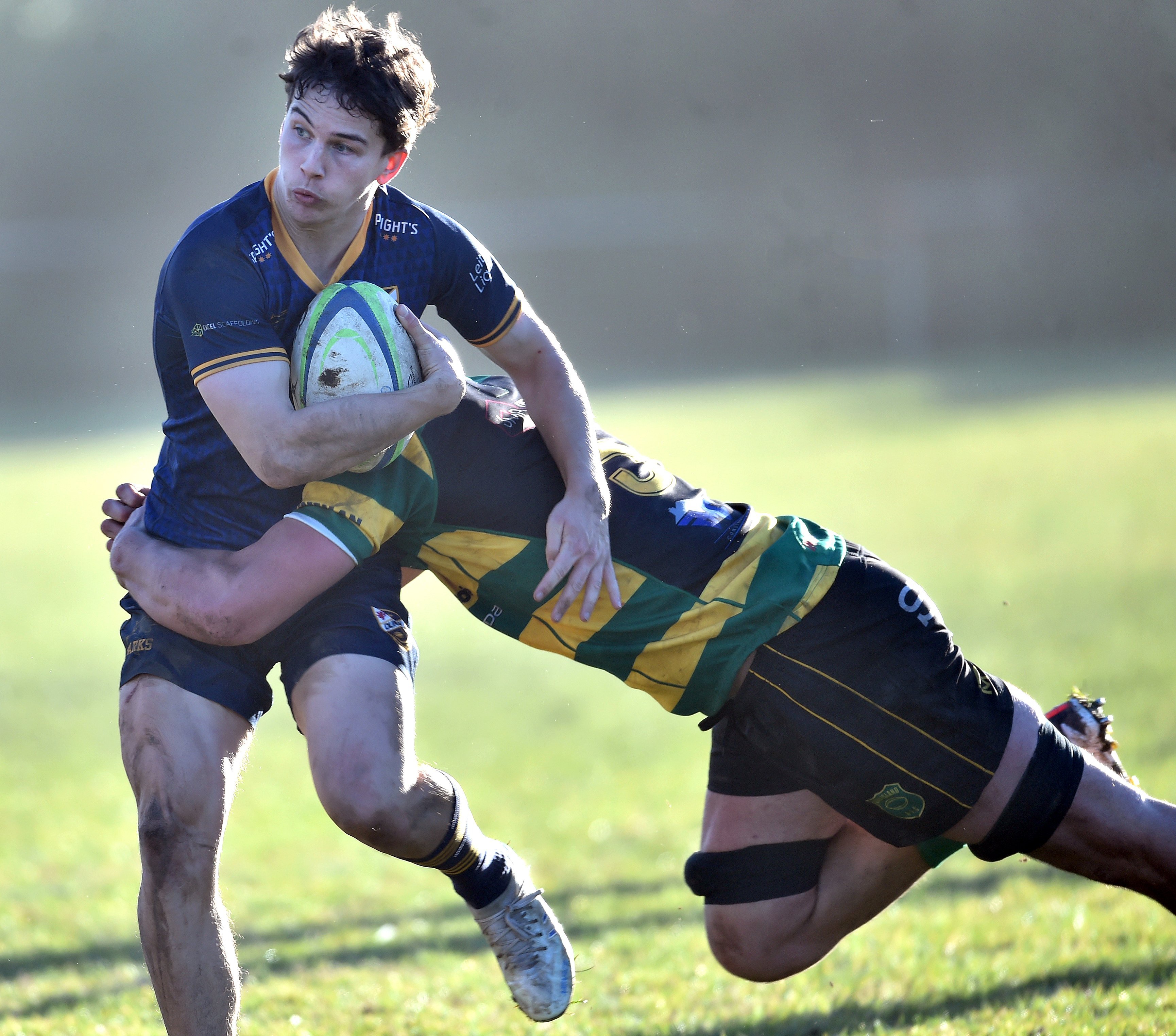 Dunedin halfback Henry Scott is tackled by Green Island lock Christian MacEwan during a Dunedin...