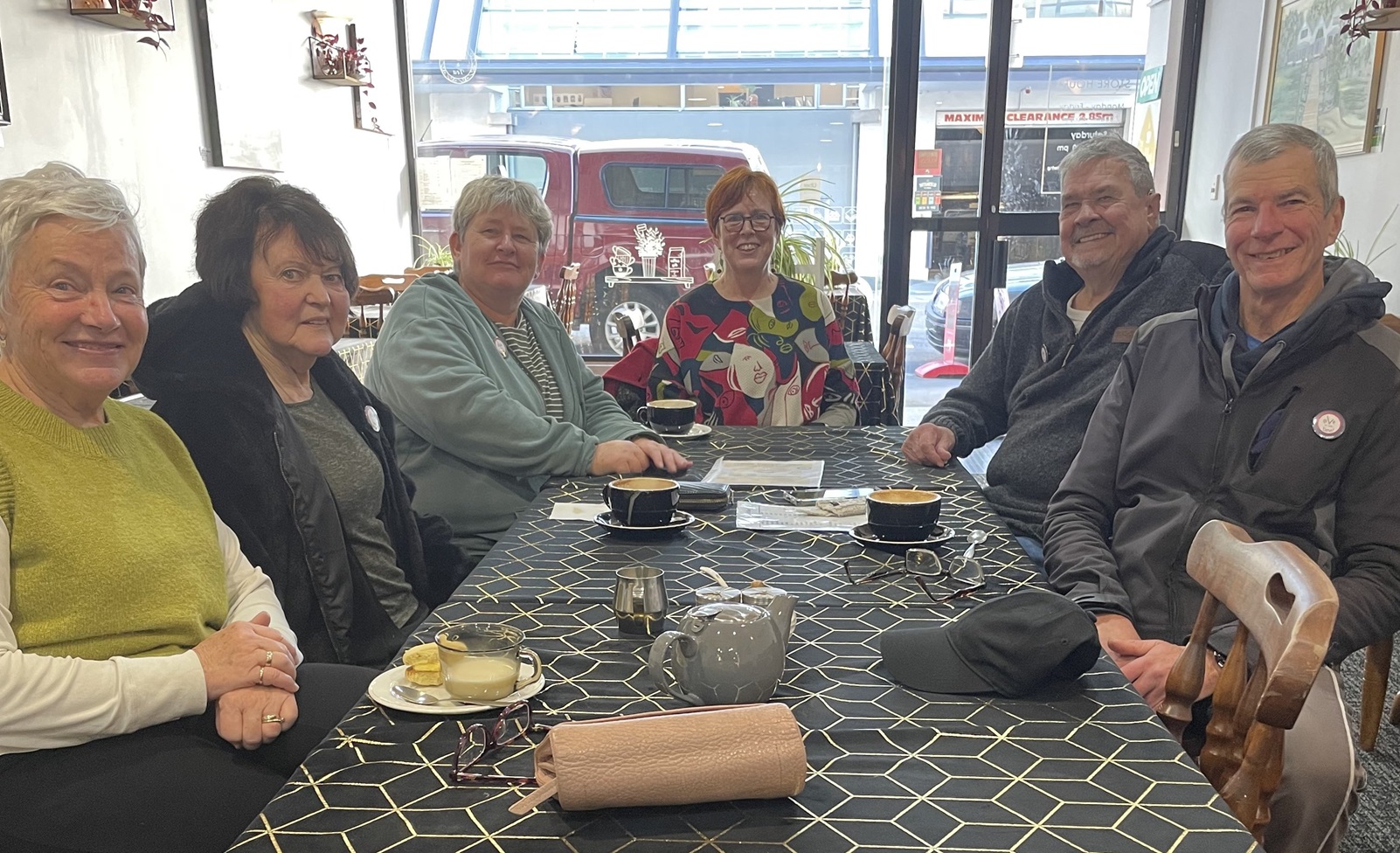 Members of a local community aphasia support group gather for coffee and conversation at a...