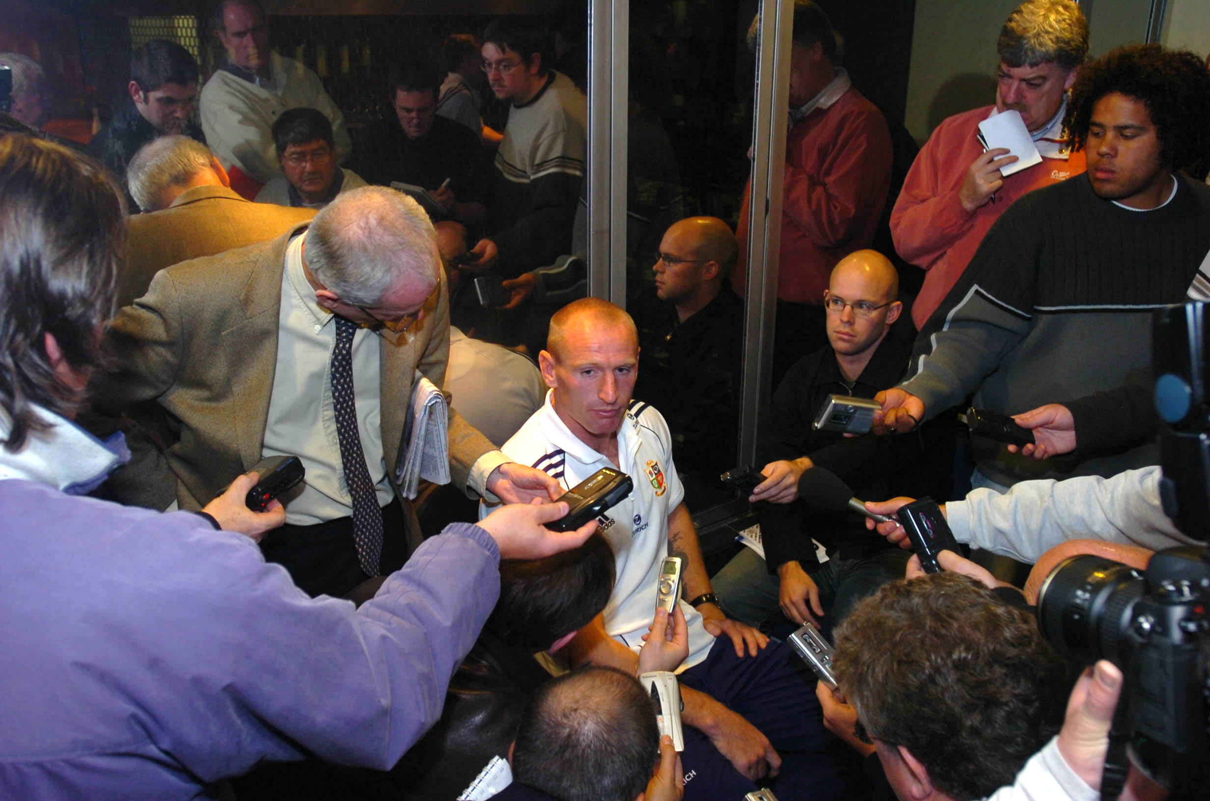 Reporters press Lions captain Gareth Thomas for insights during the 2005 tour. Reflected at the...