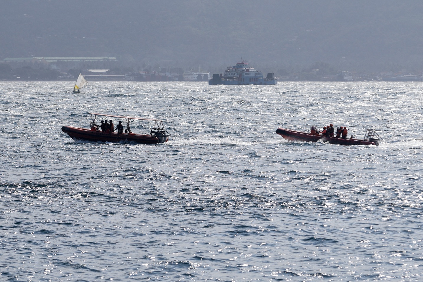 Rescue team members take part in the search for survivors after the ferry sank near the...