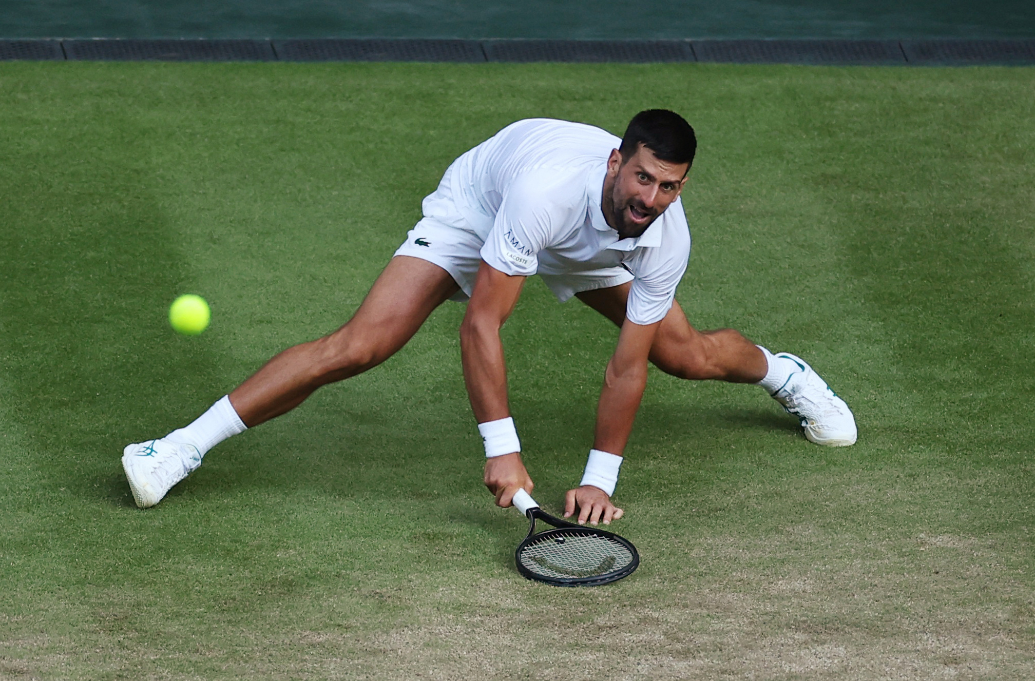 Novak Djokovic falls during his quarter final match against Italy's Flavio Cobolli. He recovered...