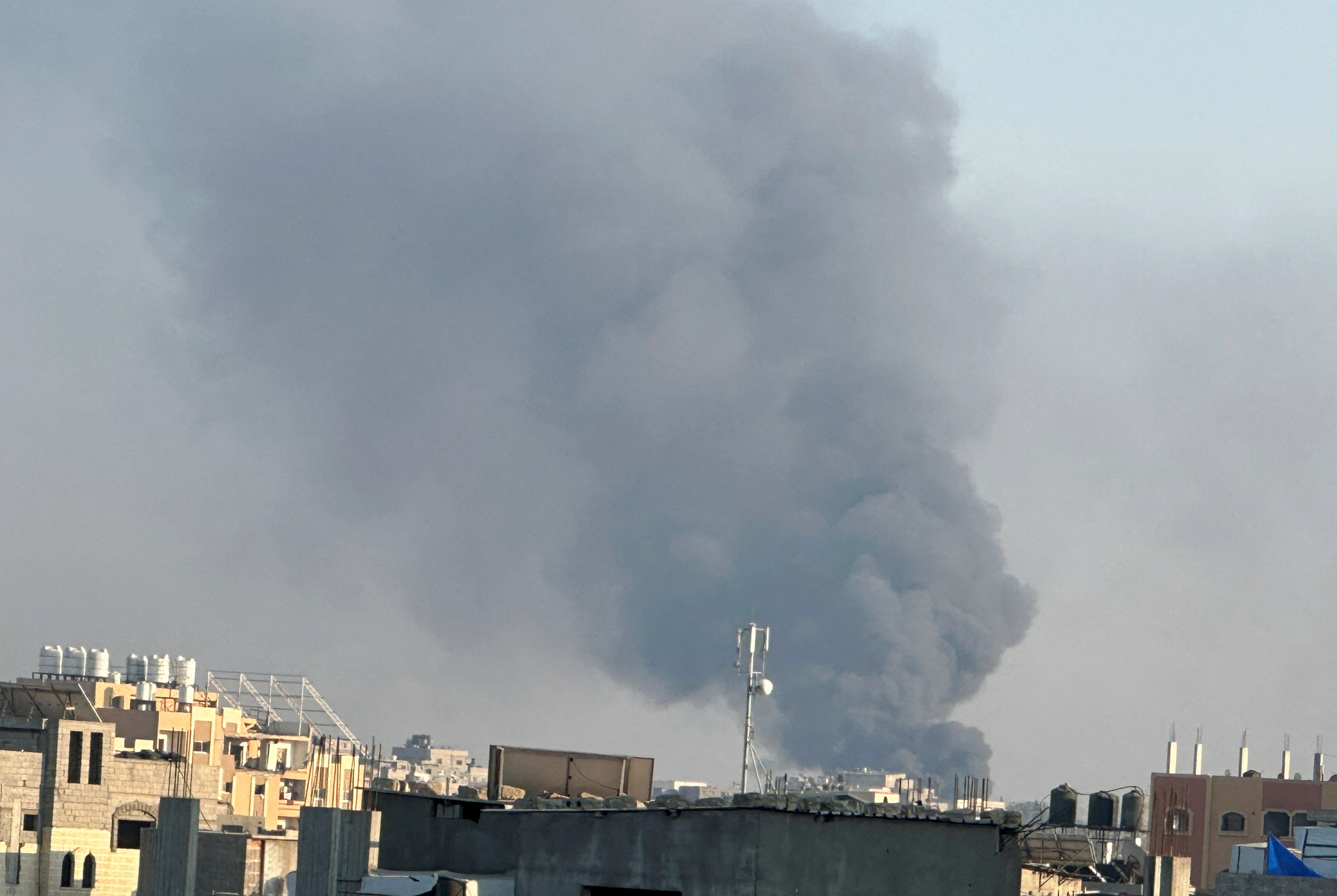 Smoke rises during Israeli strikes amid the military operation in Deir Al-Balah, in the central...