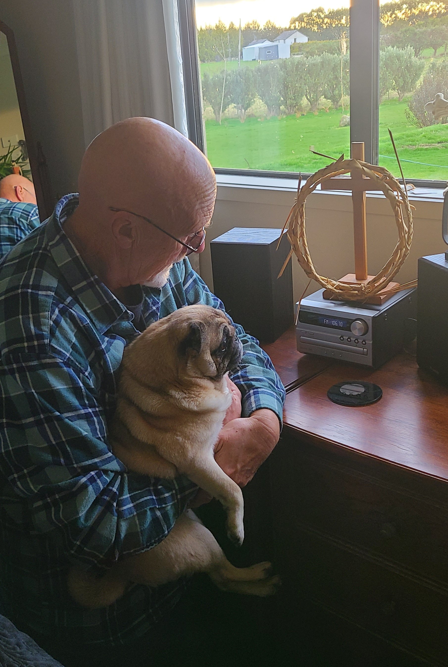 Eastside Baptist Church pastor Chris Lee and his pug Mia enjoy listening to two new radio...