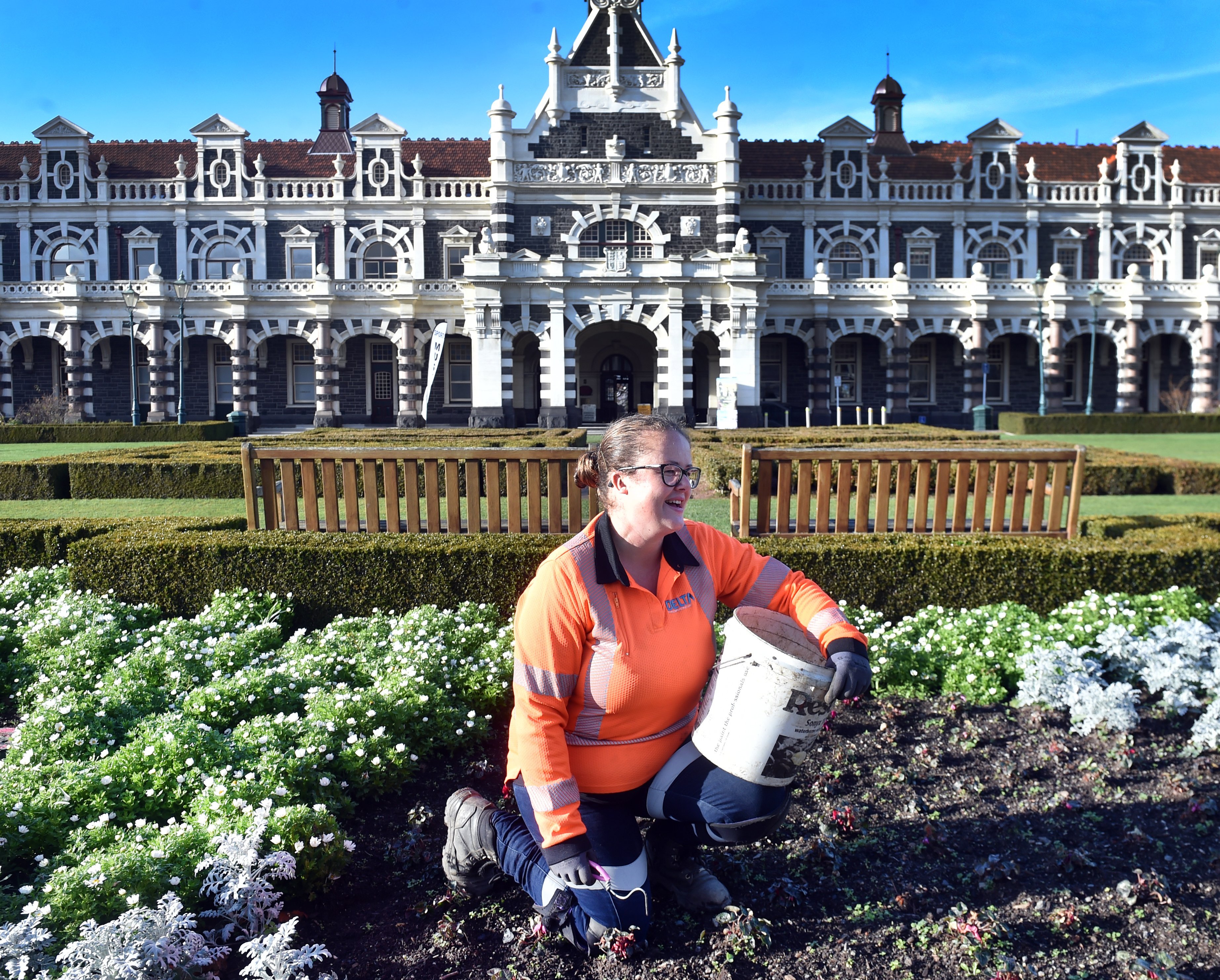 Delta gardener Nicola Kerr weeds around cyclamens in the Anzac Square garden in front of the...