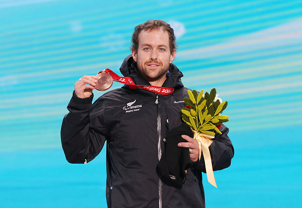 Adam Hall celebrates with his bronze medal from the para alpline skiing super combined standing...