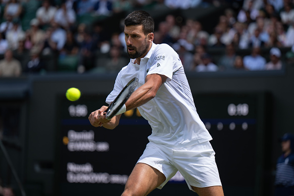 Novak Djokovic plays a backhand during his win at Wimbledon overnight. Photo: Getty Images