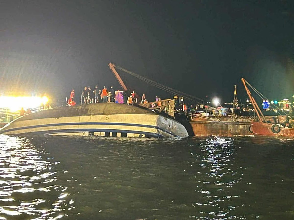 Emergency services attend to a capsized tourist boat, which was believed to be carrying more than...