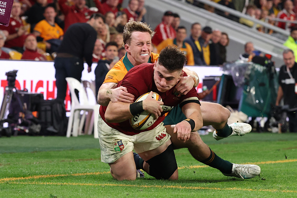 Dan Sheehan of the Lions scores his team's third try despite the efforts of Wallaby Harry Potter...
