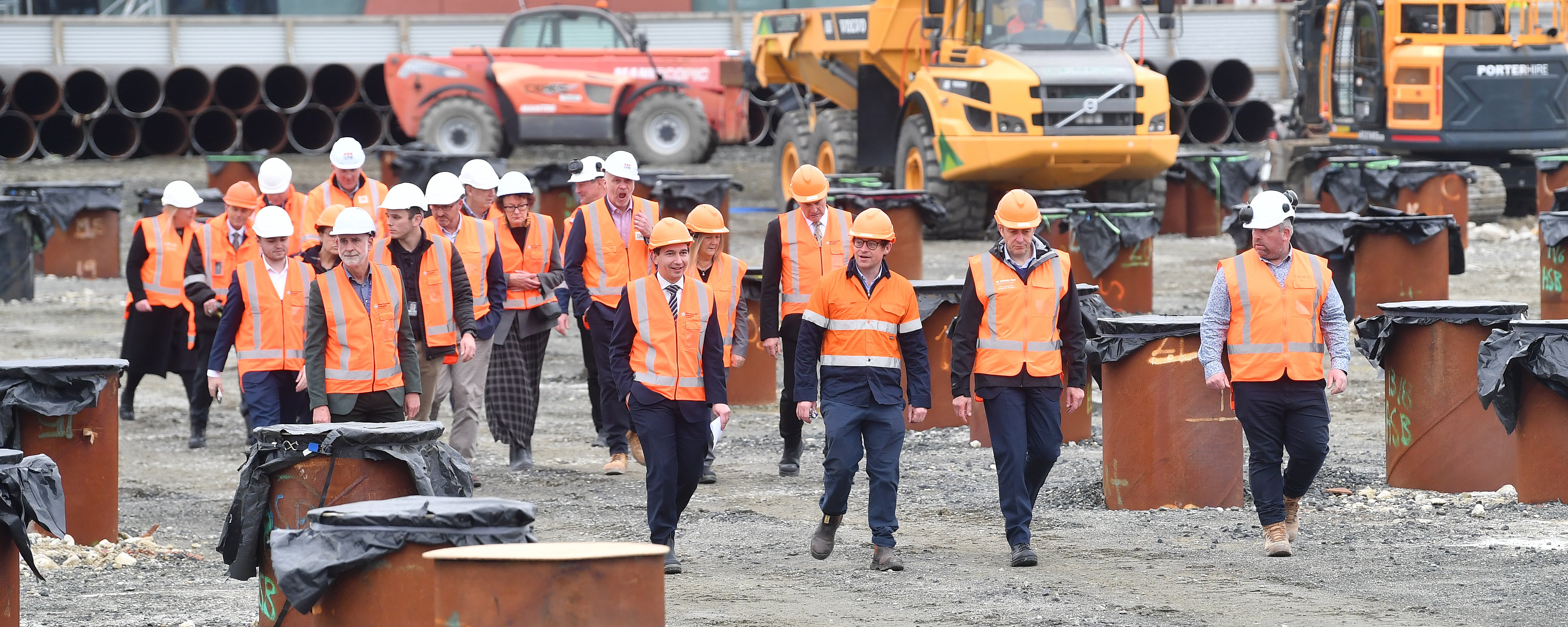 Health Minister Simeon Brown (front, fourth from right) and his entourage walk through the new...