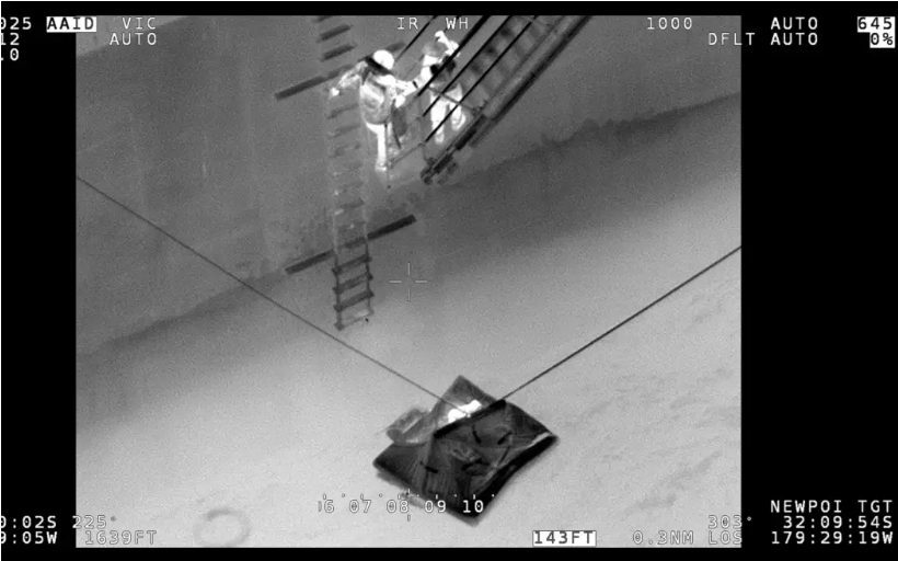 A life raft alongside a merchant vessel. Photo: NZDF / supplied