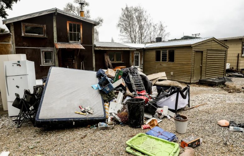 Flood damaged items piled up outside a property in the Motueka Valley. Photo: RNZ / Marika Khabazi