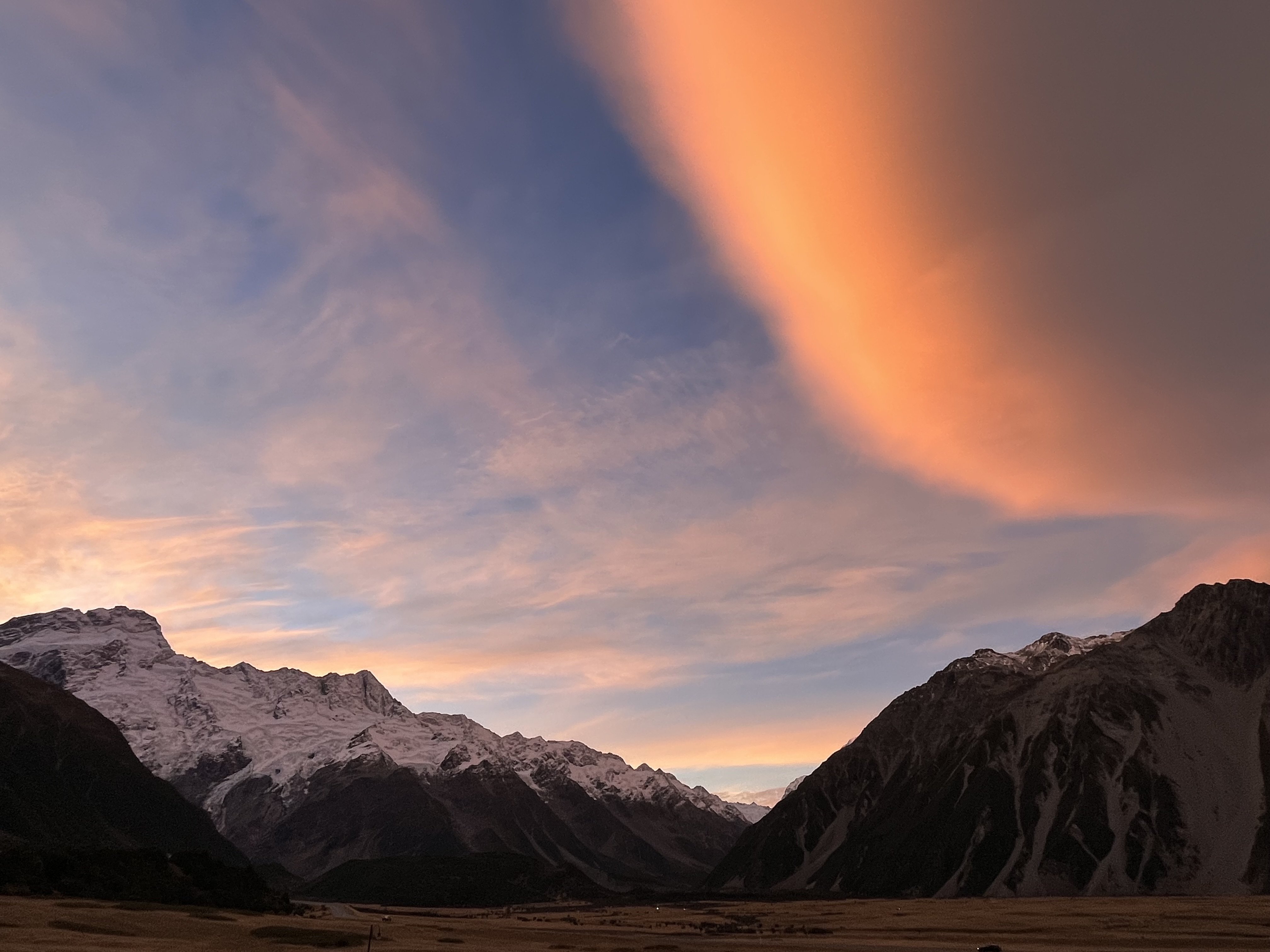 Mt Sefton and the Footstool looming over the village, highlighted by a sunset-tinged lenticular...