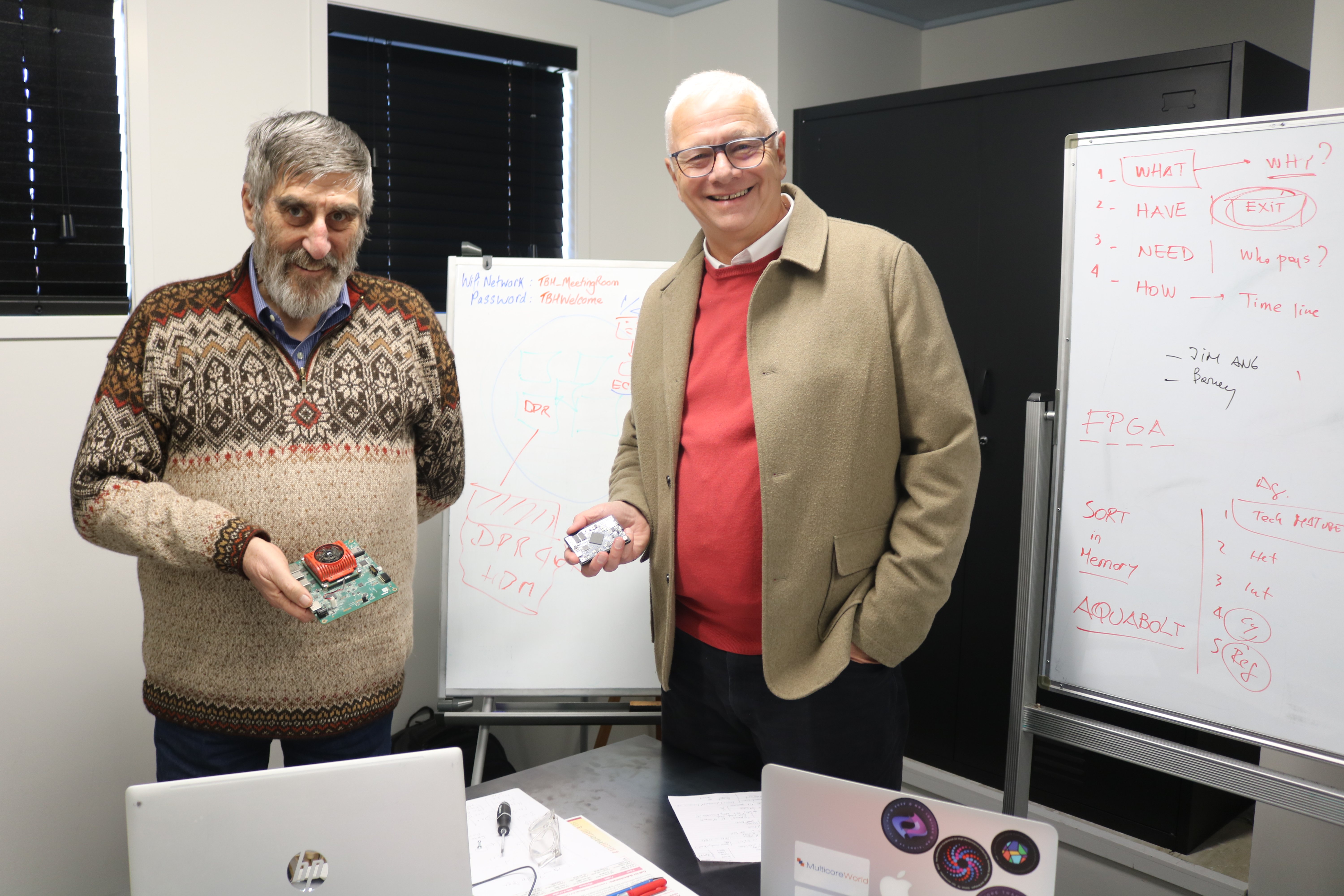 IT experts Robert Trout (left) and Nicolas Erdody hold circuits known as field-programmable gate...