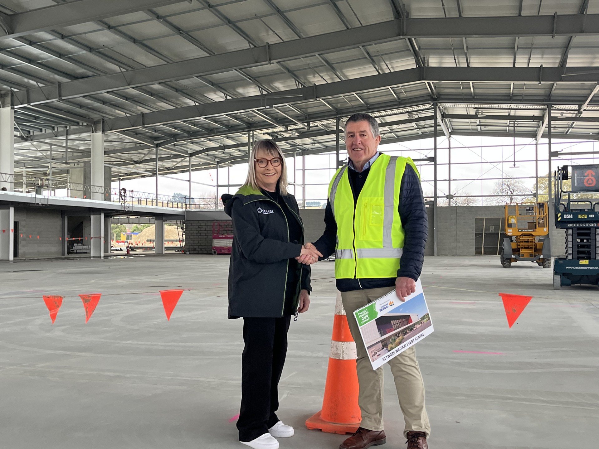 Otago Community Trust grants manager Sue Stewart shakes hands with Waitaki Event Centre Trust...