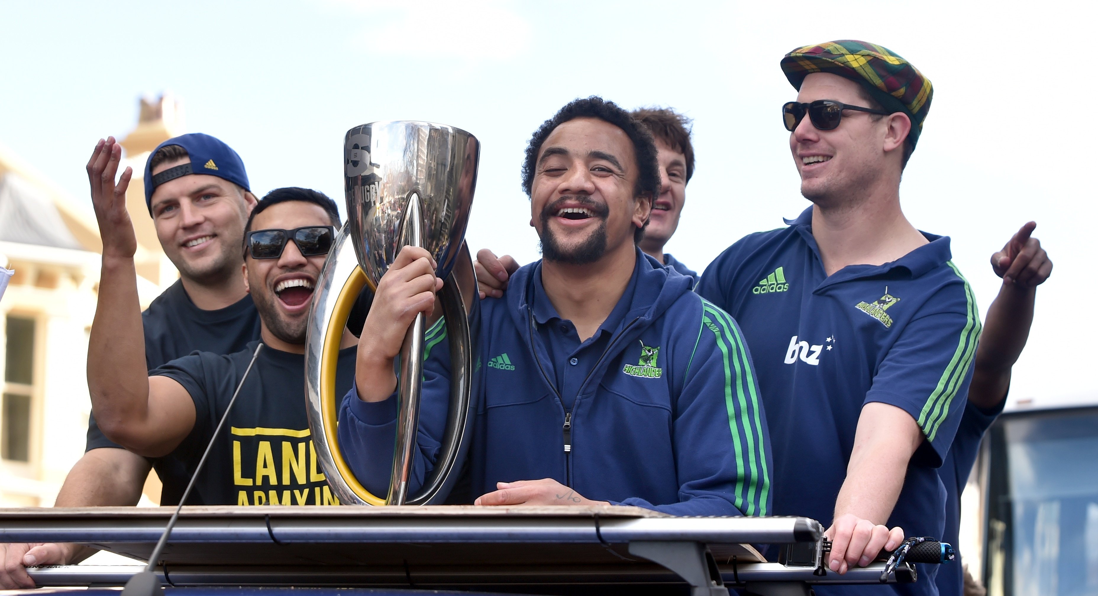 Highlanders co-captain Nasi Manu holds the Super Rugby trophy during the championship parade in...