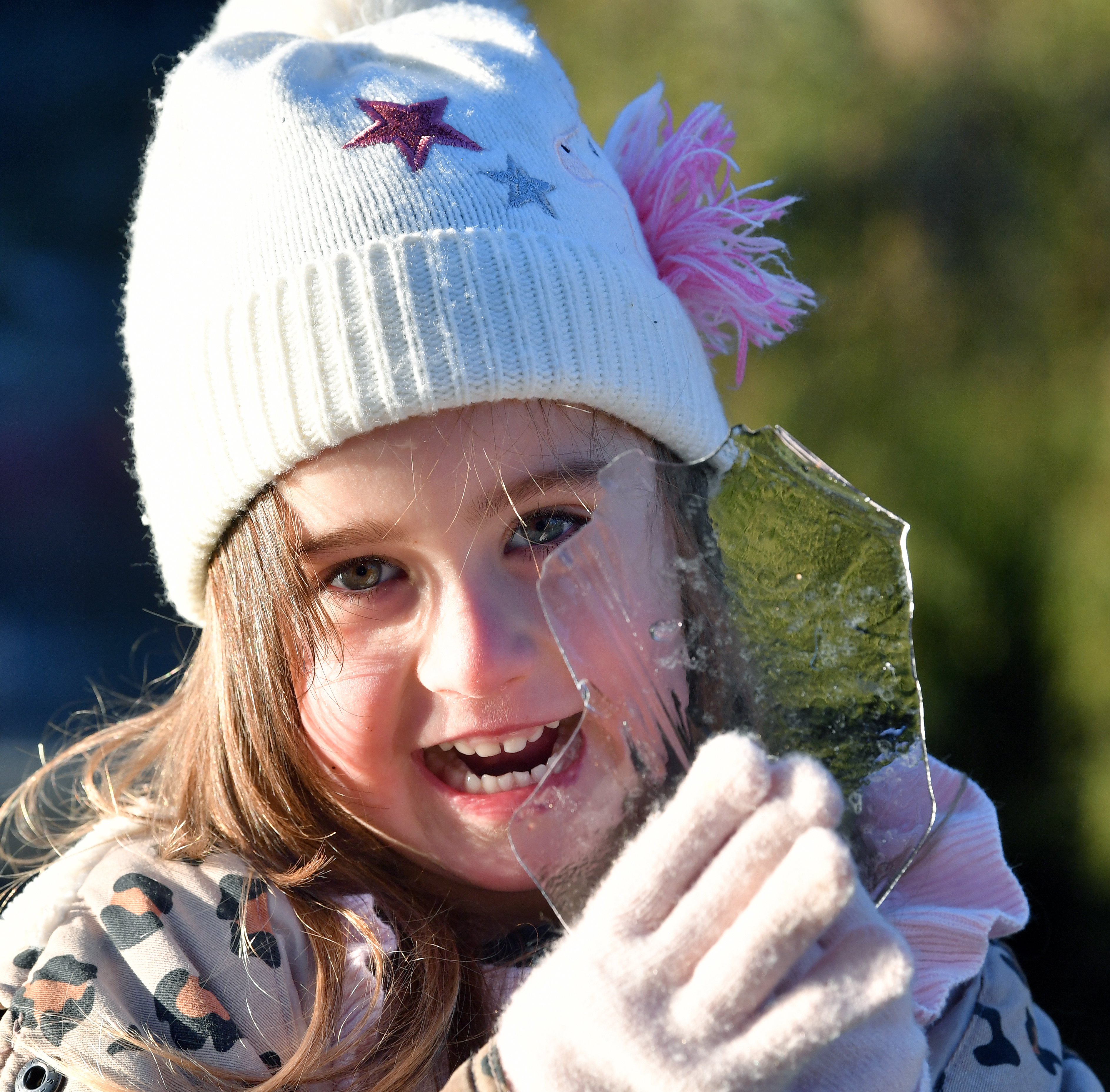 Mirana Hobman, 4, plays with ice from the garden’s frozen pond.

