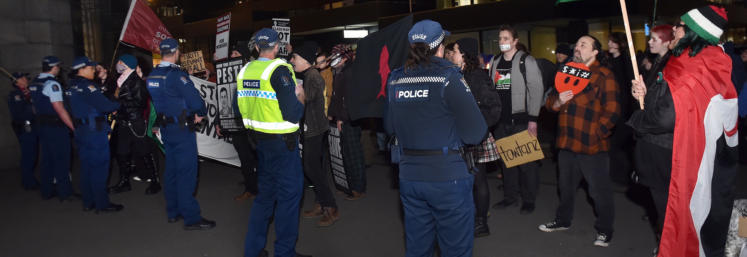 The police guard the Liverpool St entrance to the Distinction Hotel as protesters demonstrate...