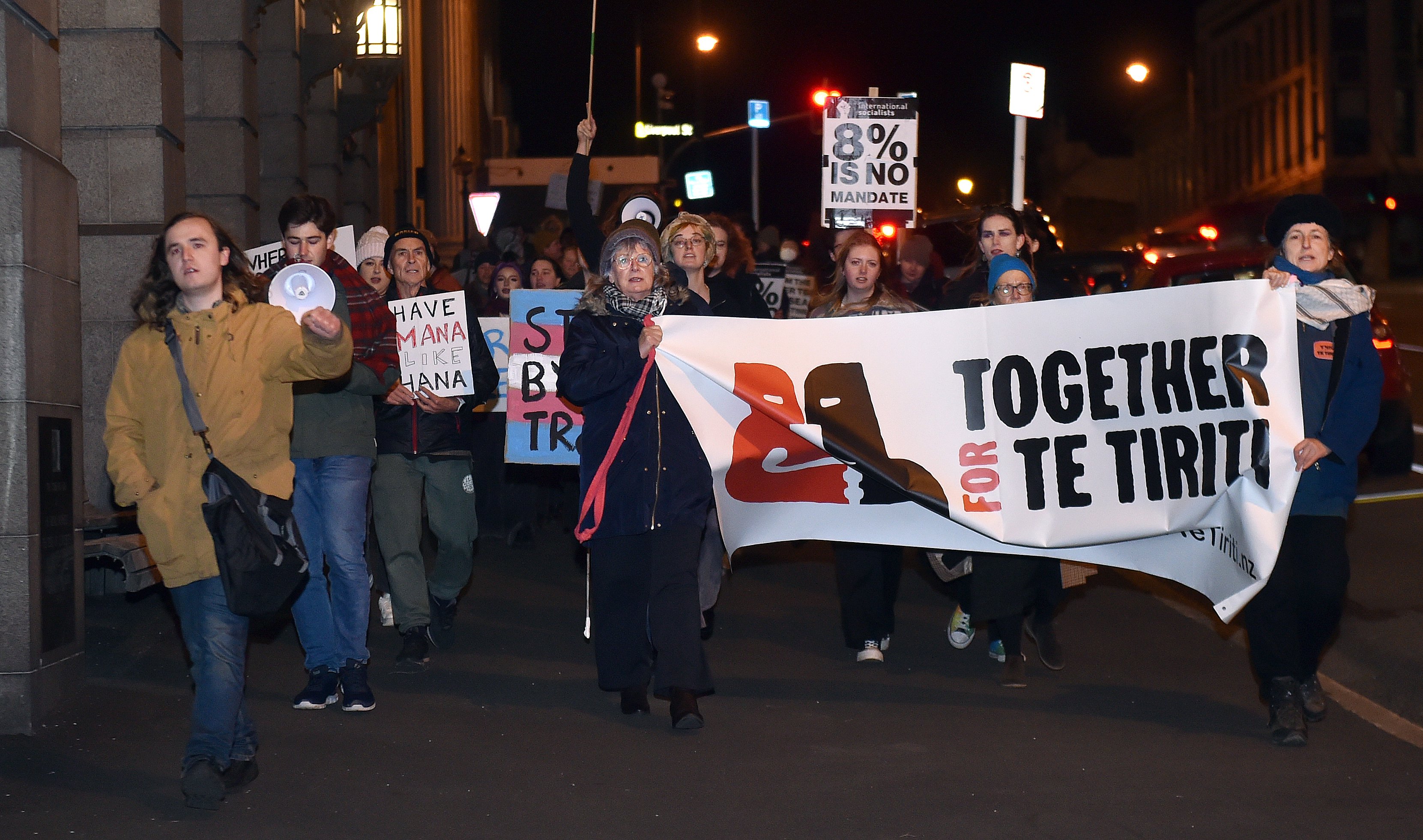 Demonstrators march in a loop around Dunedin's Distinction Hotel where deputy prime minister and...