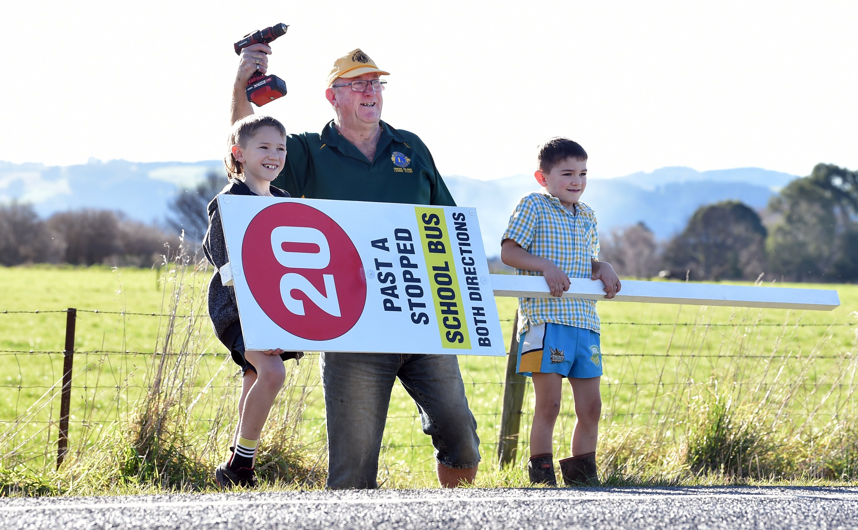 Outram School bus driver Ken Schumacher, flanked by brothers Walter, 8 (left), and George...