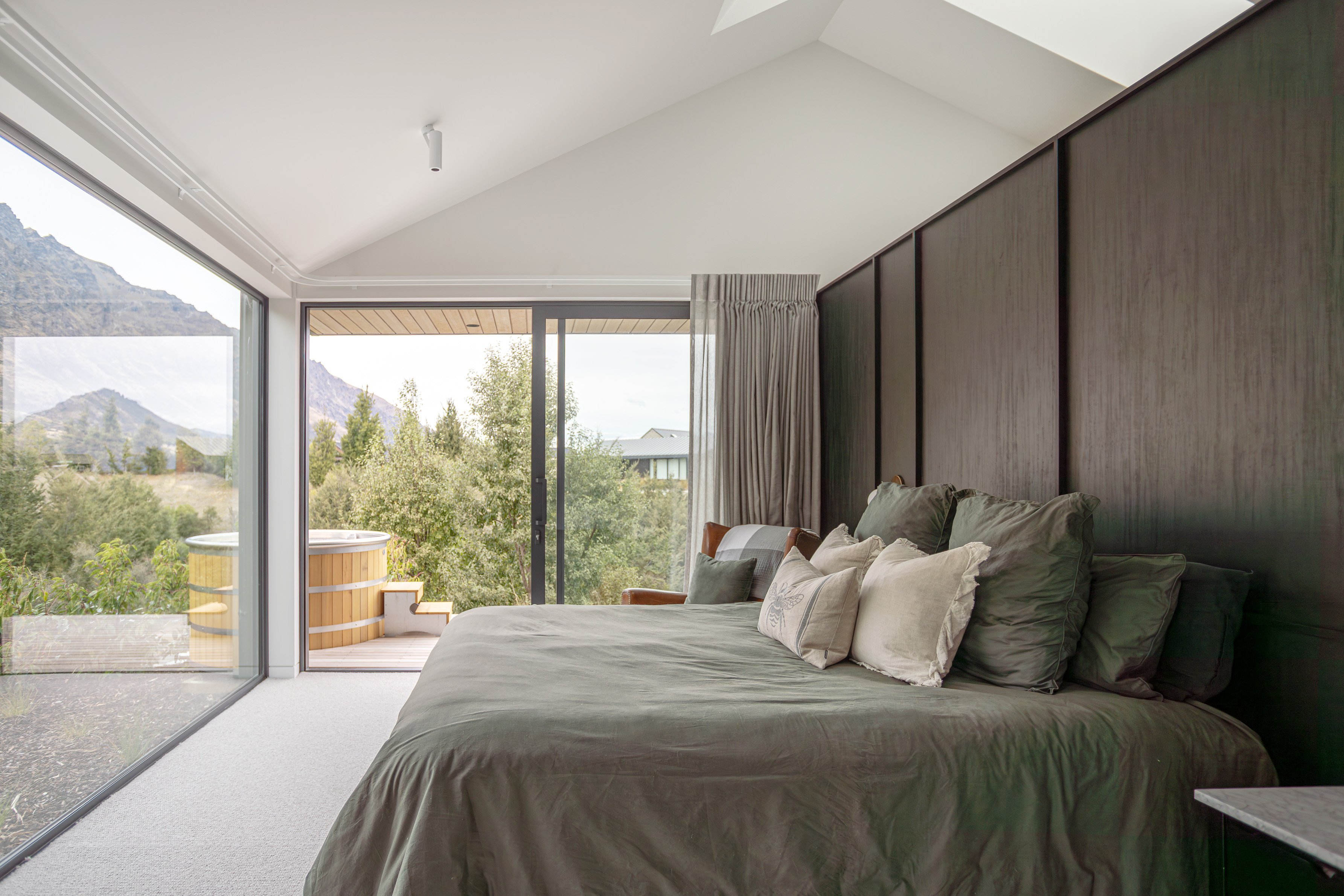 The main bedroom offers views of The Remarkables mountain range. Wall panelling adds character...