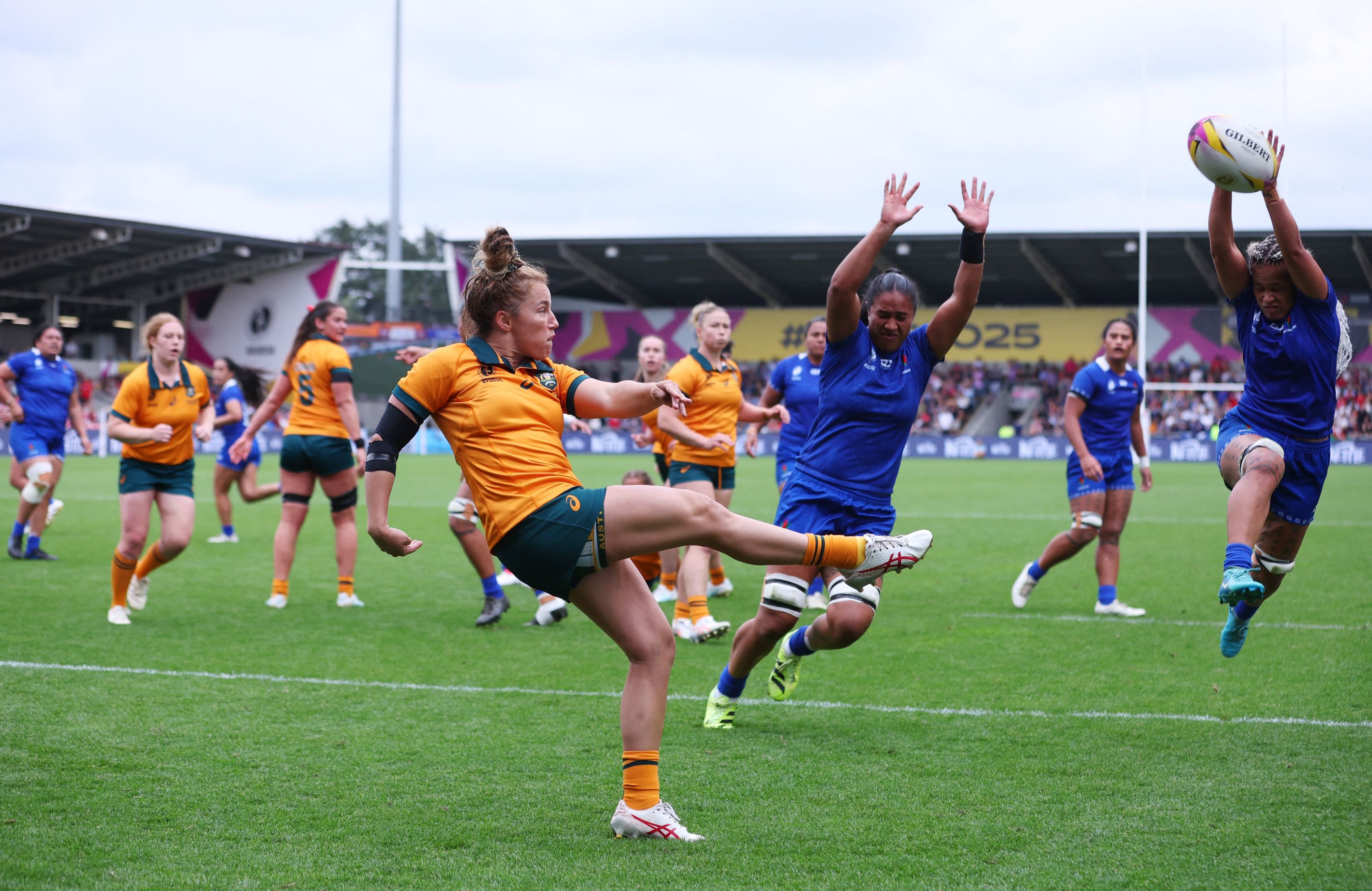 Australia’s Maya Stewart kicks the ball clear as Samoa’s Sui Pauaraisa attempts to charge it down...