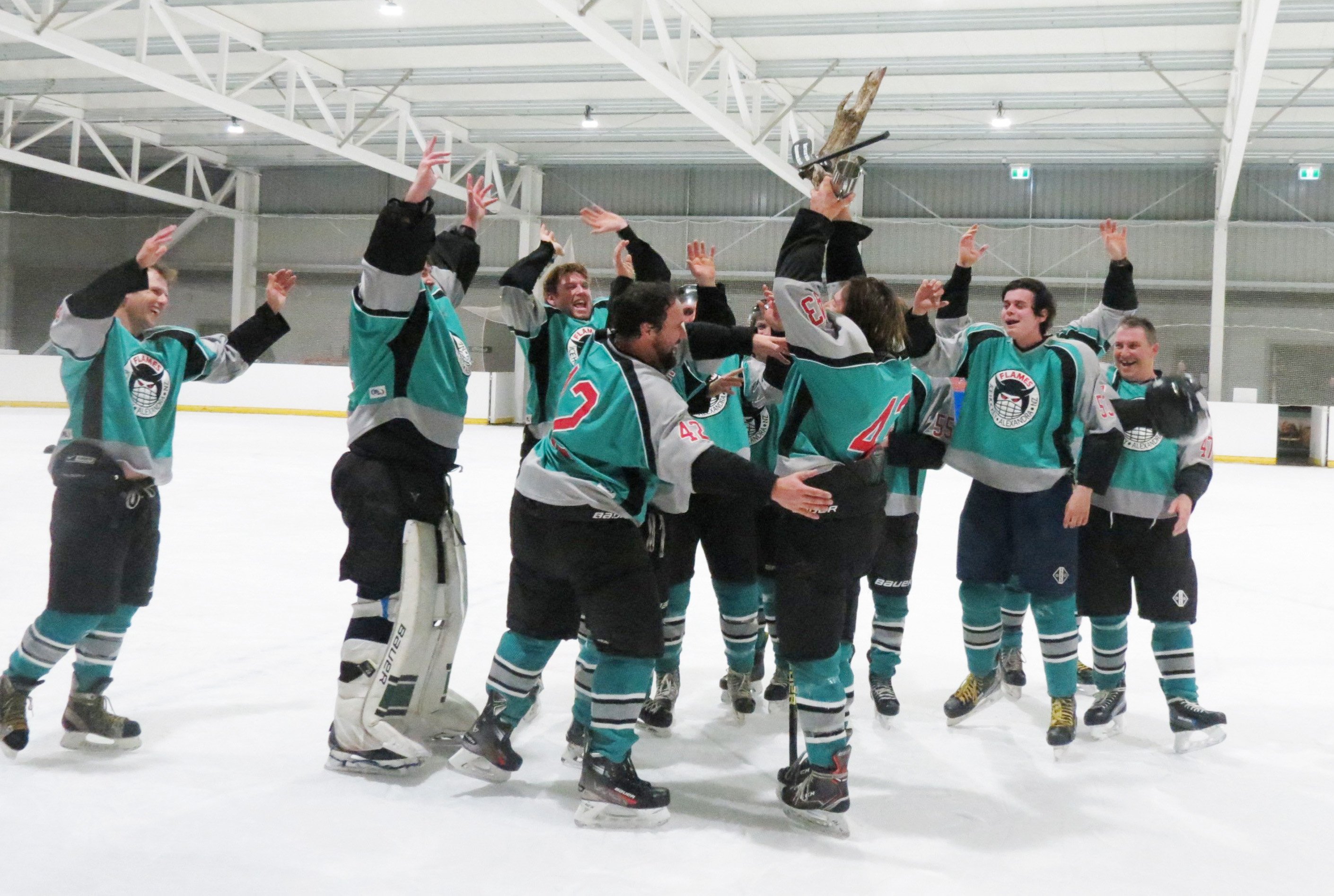 Alexandra Flames players celebrate as they lift the Champagne Gully Cup for the first time after...