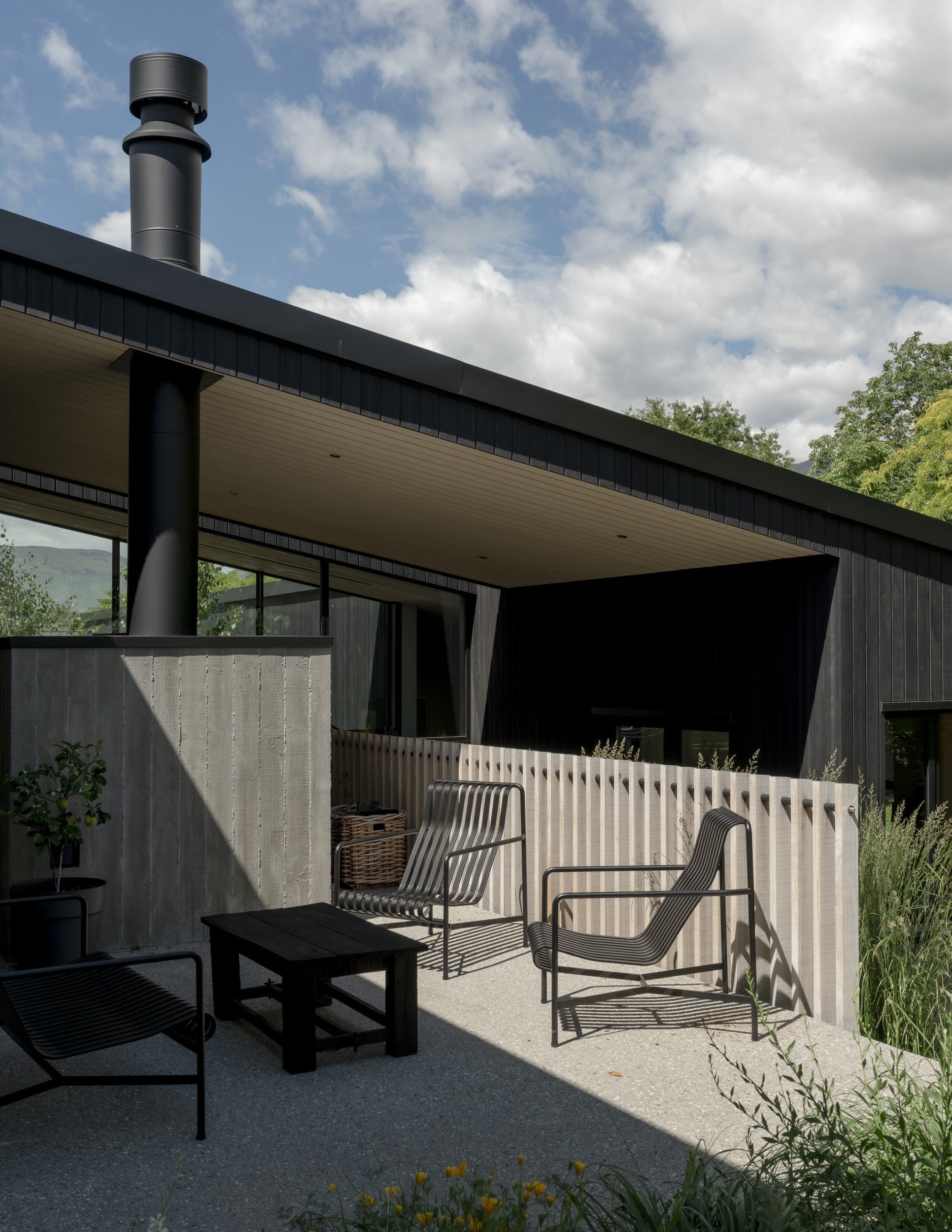 A patio opens off the kitchen and dining areas. The owners wanted a warm, low-maintenance home...
