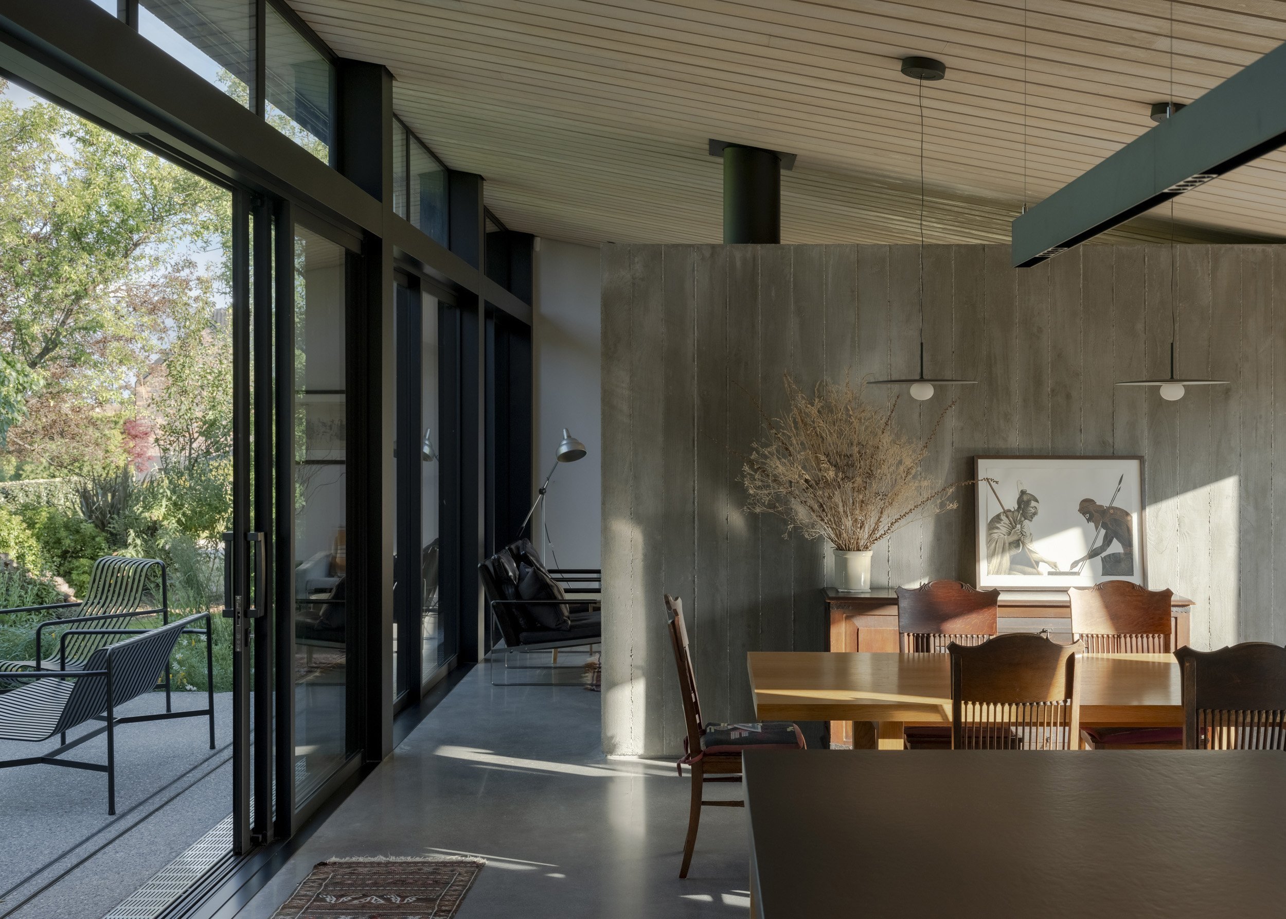A covered outdoor room opens off the kitchen. External wooden screens can be positioned to block...