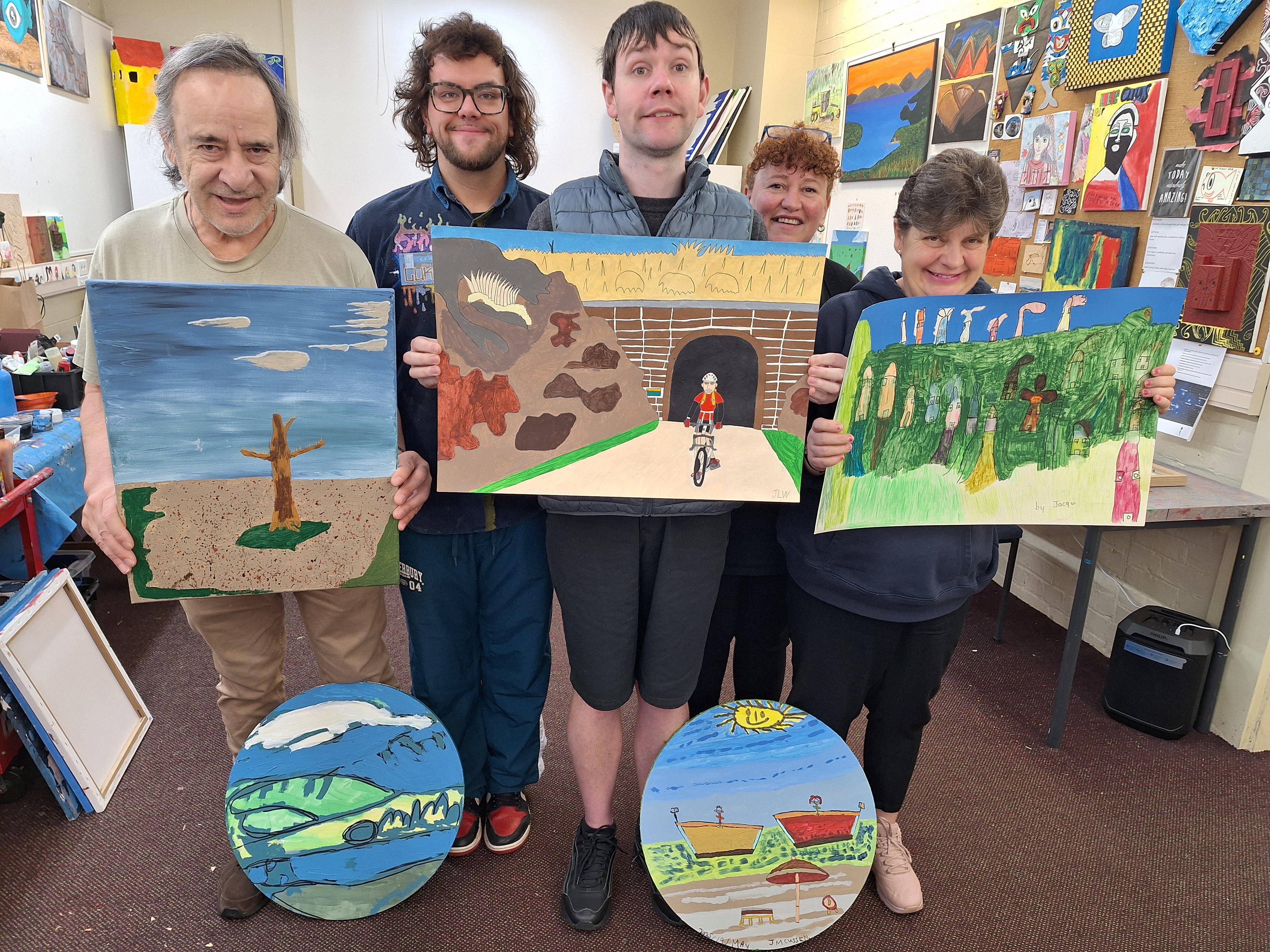 C.S. Art Studio tutors Luke (back left) and Michelle Dawson guide artists (front, from left) Owen...