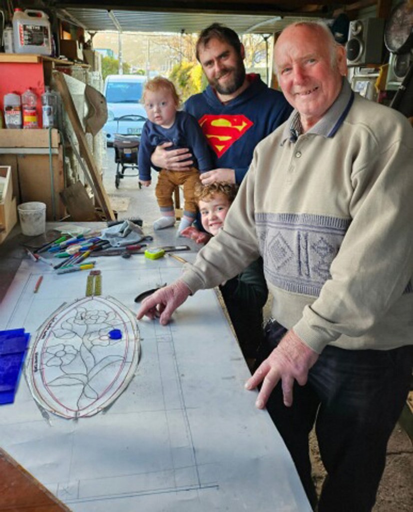 Leadlight maker Chris Watts in his workshop with great-grandson Billy Casey, 2, grandson-in-law...