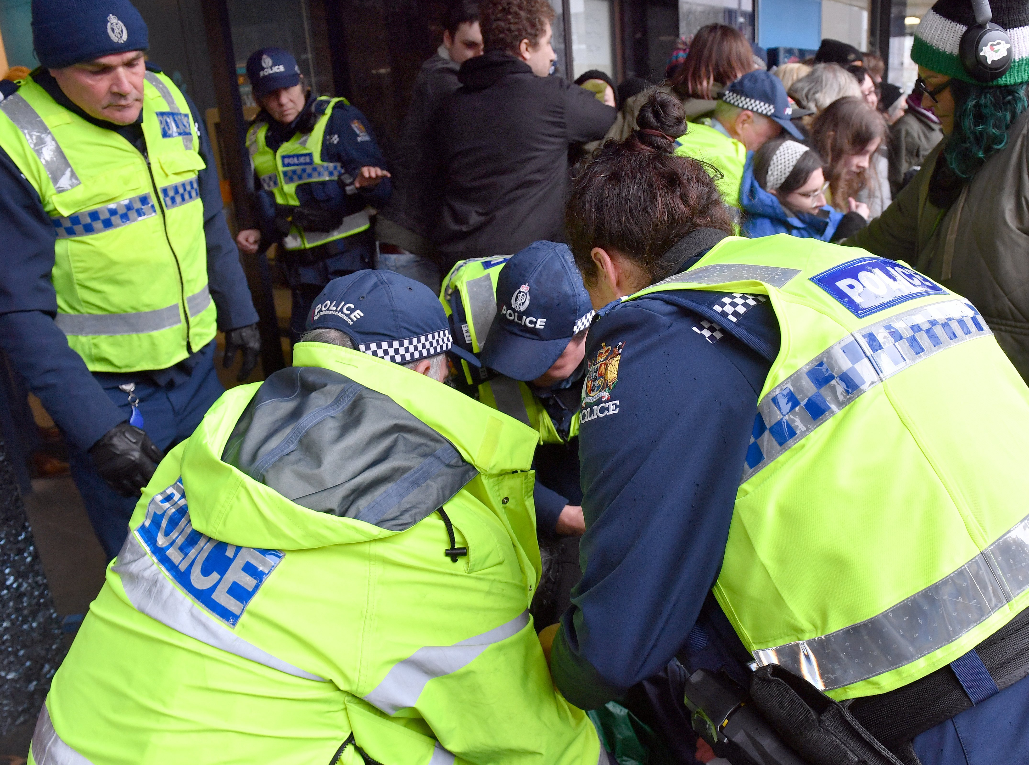 Dunedin police assist a pensioner after she fell while attempting to enter the bank which was...