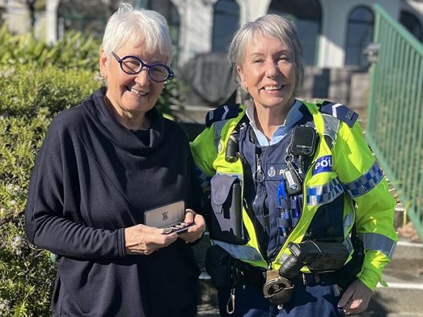 Kay Hunter receives one of her late husband's medals from Senior Constable Nyanne Graf-Pollard....