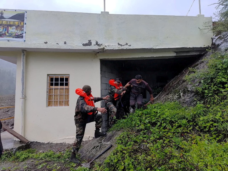 Rescuers assist a man, amid flash floods, in Dharali, Uttarakhand, India. Photo: Reuters