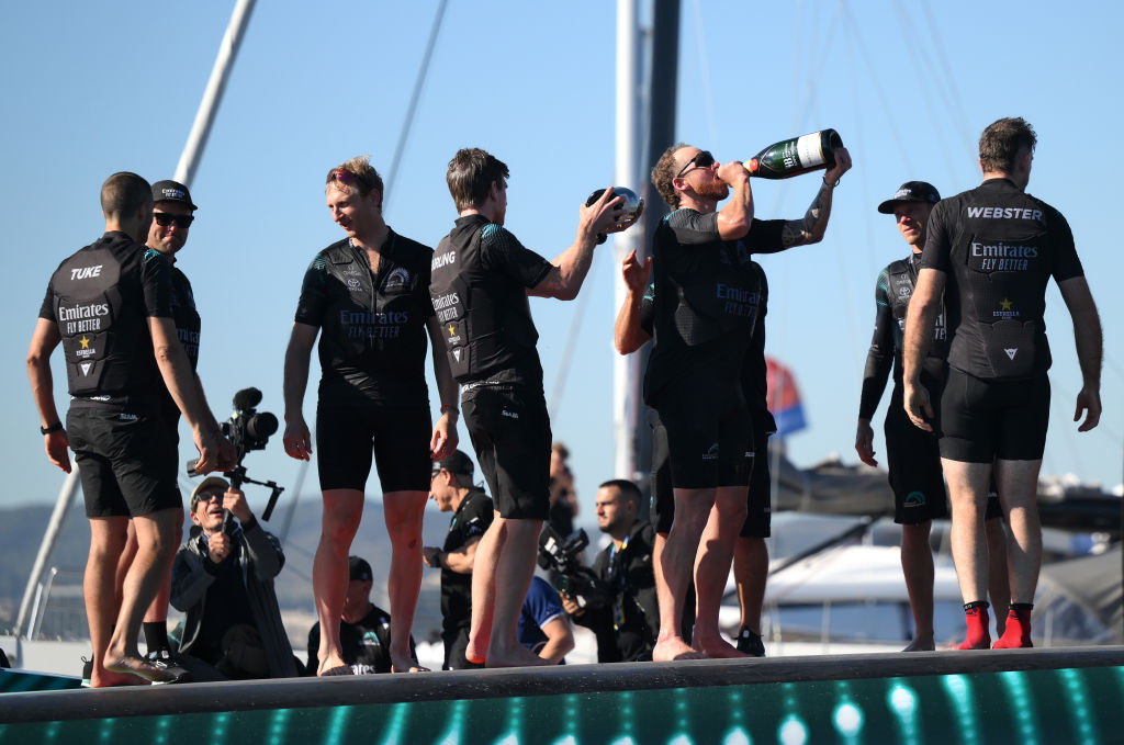 Hamish Bond (third from left) celebrates with Team New Zealand after beating Britannia in the...