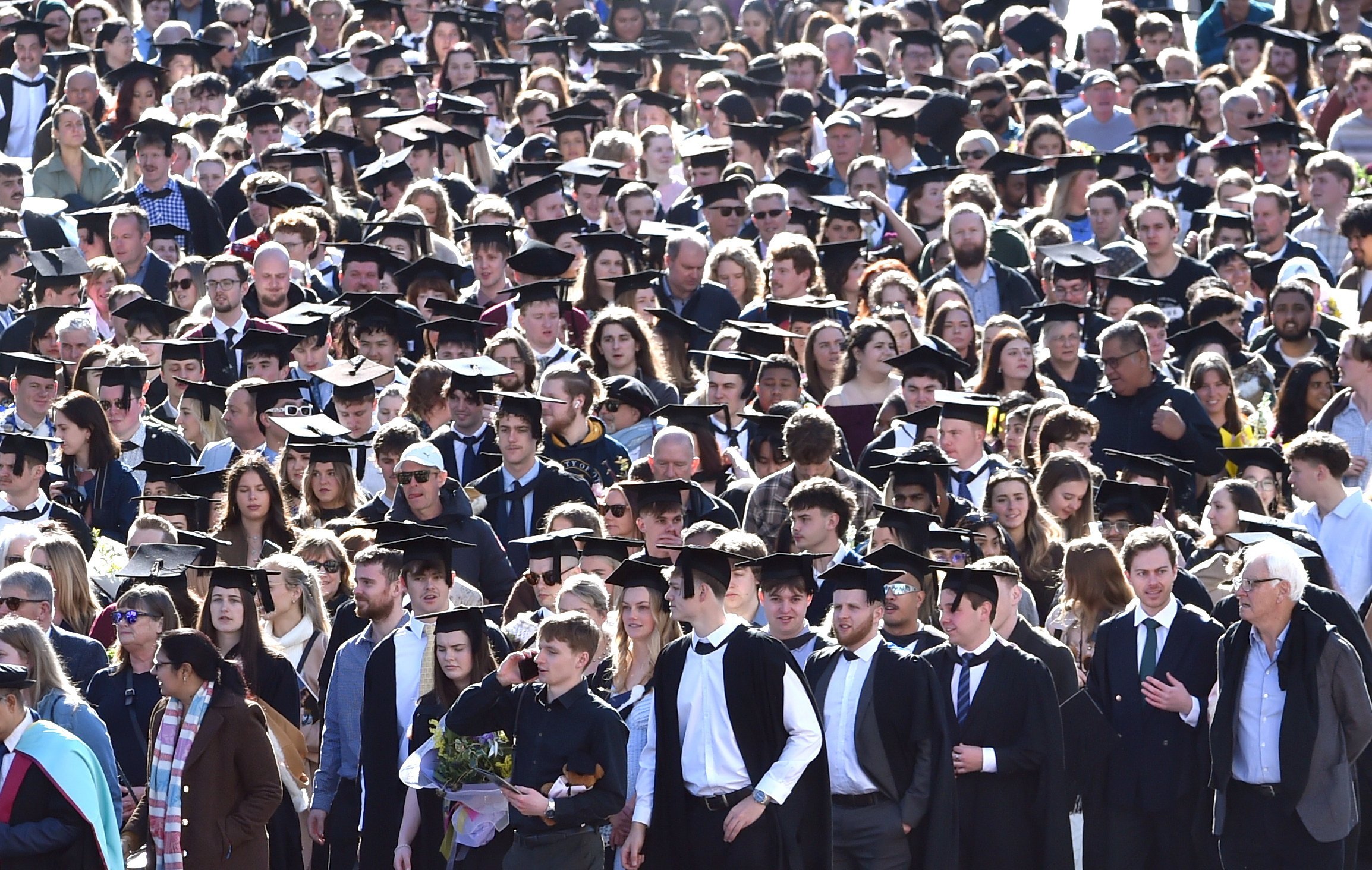 A crowd gathers for the University of Otago graduation parade.