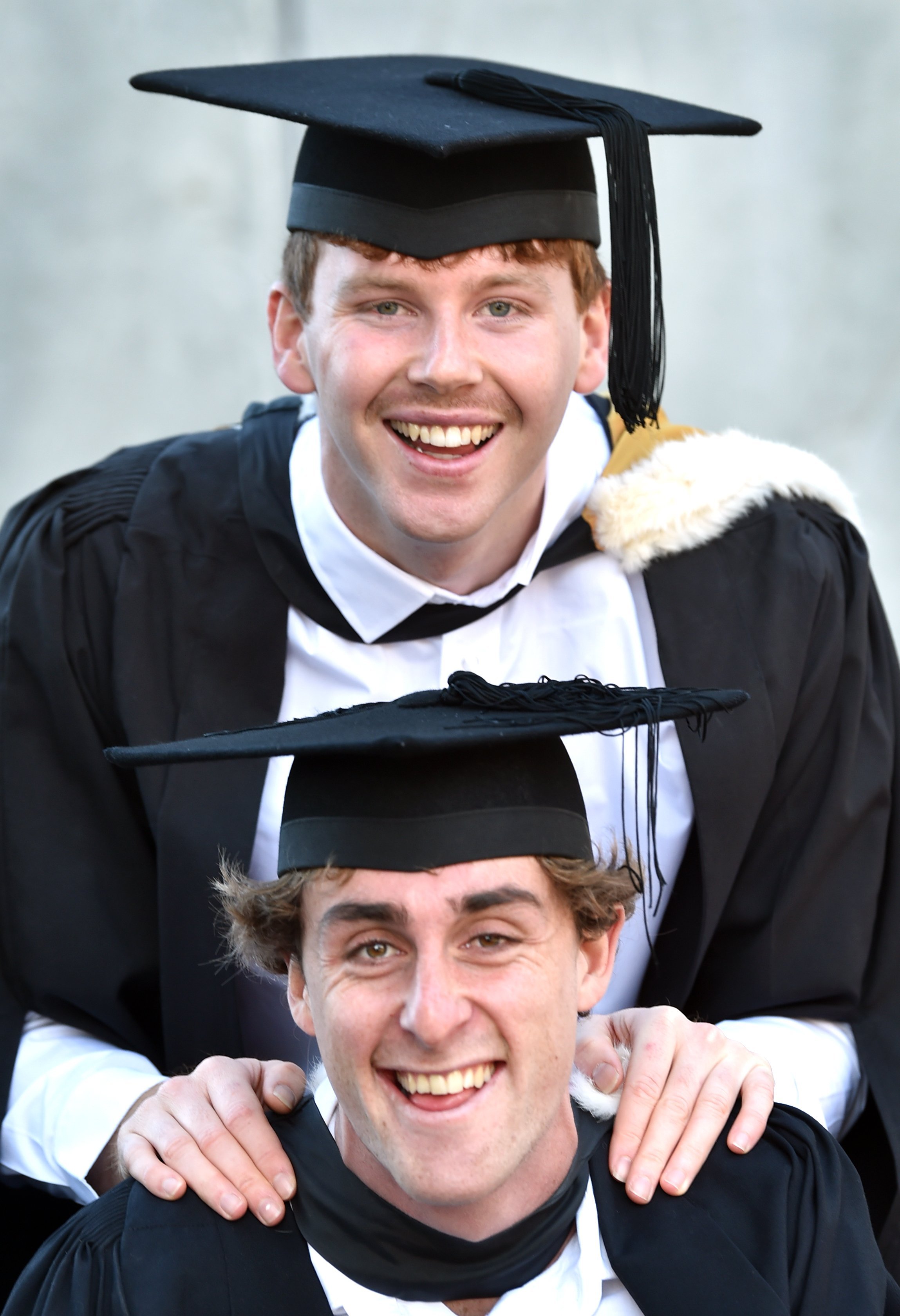 Good friends Charlie Stenberg (top) and Reuben Irwin, both 21, graduated together on Saturday.